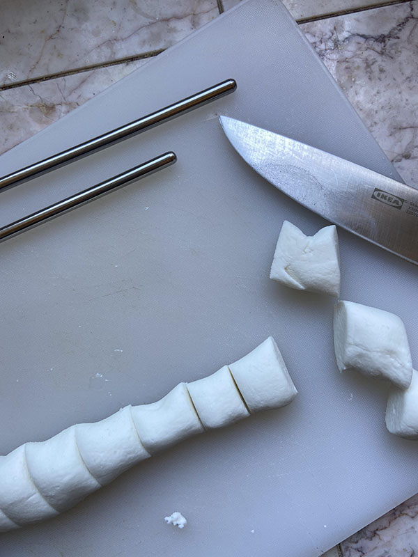 cutting mochi dough into little pillows